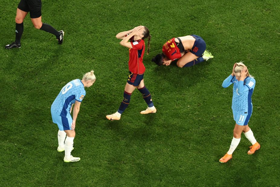 Players from Spain and England react after the final whistle.